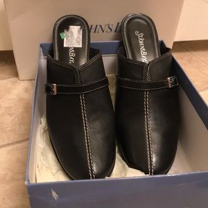 Black mule with white stitching.